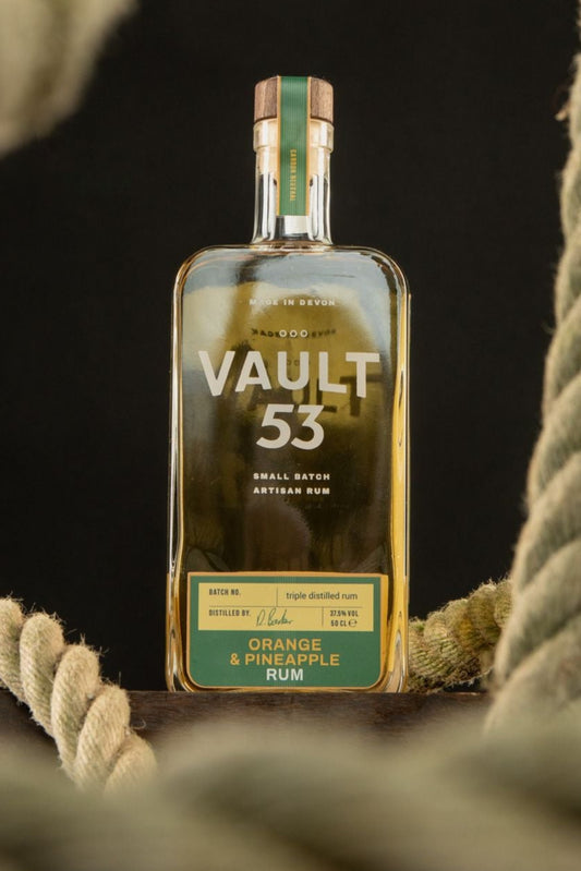 A bottle of Vault 53 Orange & Pineapple rum in the backdrop of a rope