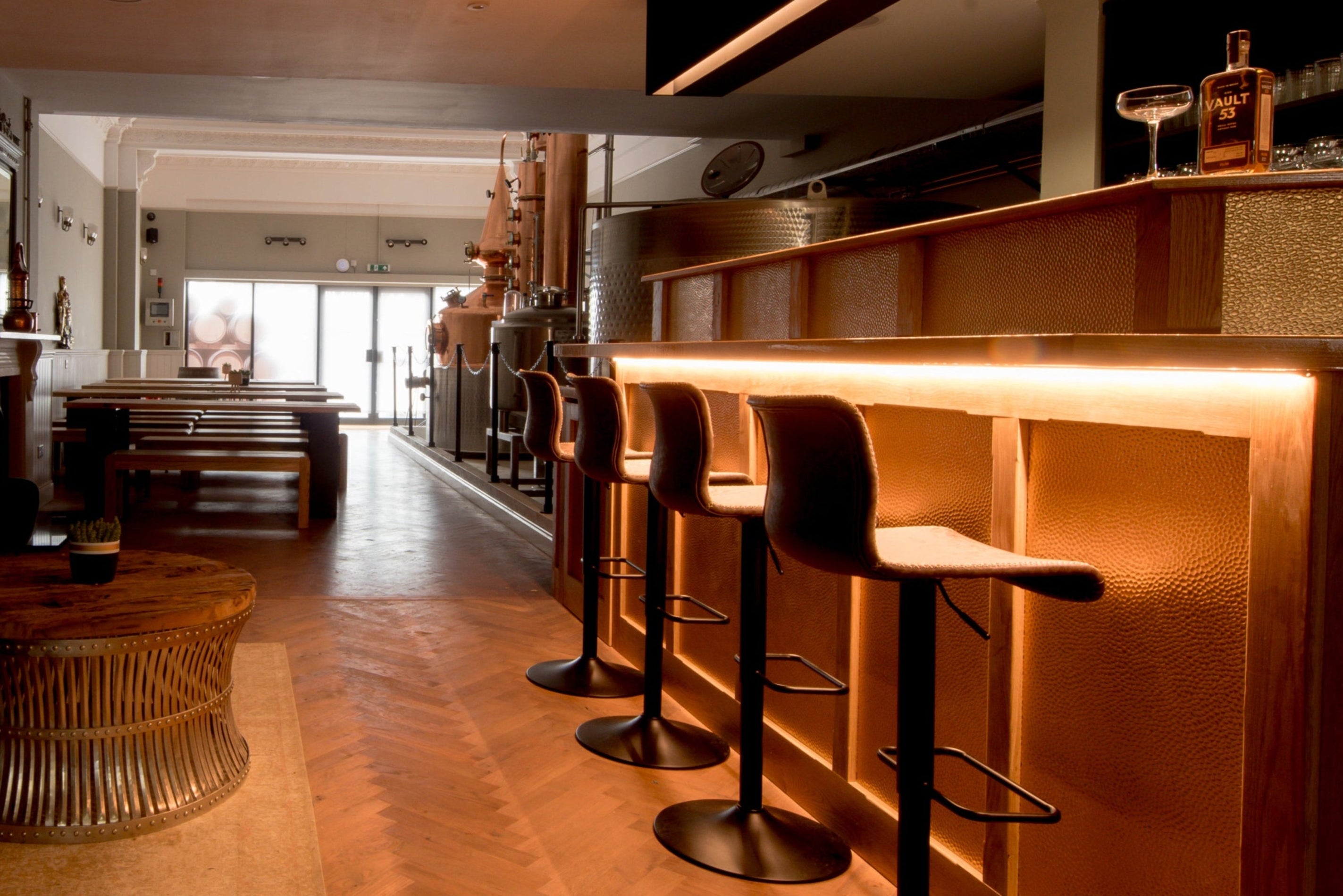 A picture of the distillery in the evening with the bar lights on at Vault 53