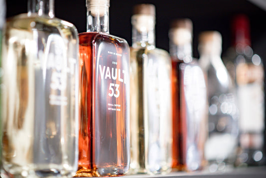 Bottles of 'VAULT 53' on a bar with blurred background